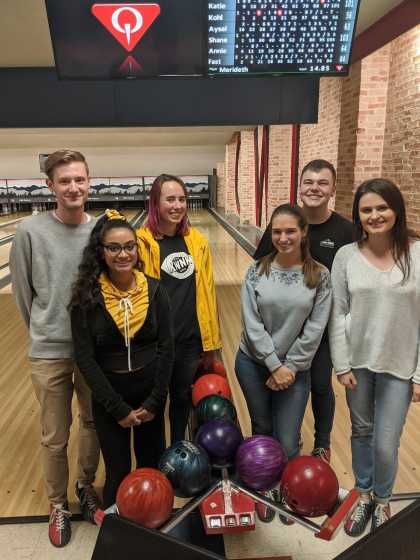 Lab students pose in front of a bowling alley